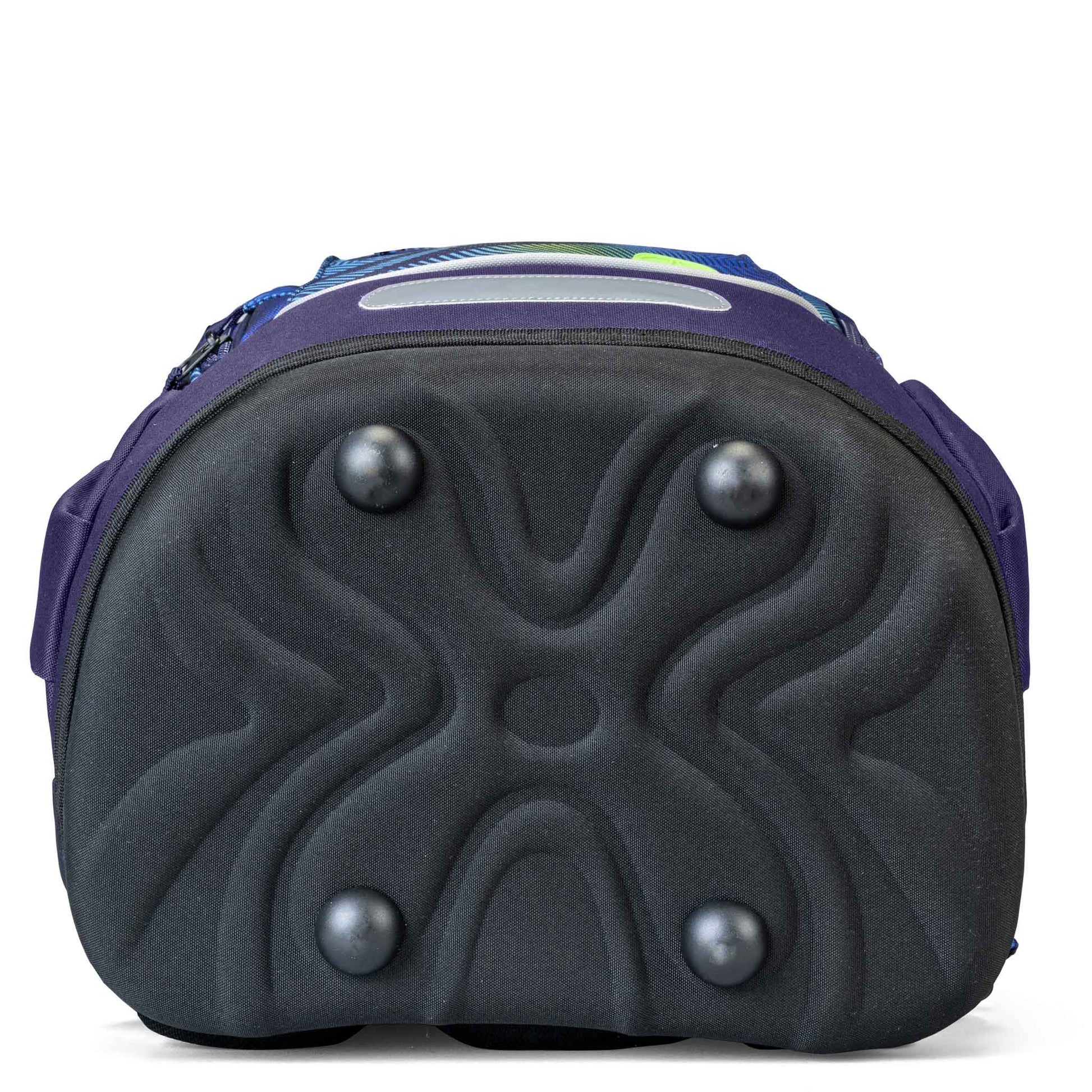 School backpack bottom view showing moulded black rubber base with four metal feet studs and purple zip trim, blue-green patterned fabric visible above